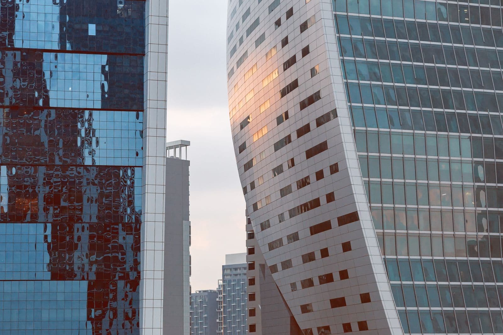 Close crop of glass-clad office towers in Dubai's financial district